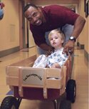 Football player Donovin Darius with a young patient at Wolfson